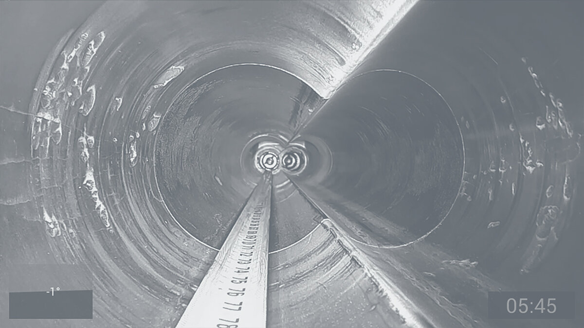 View of the inside of a damaged extruder with tape measure